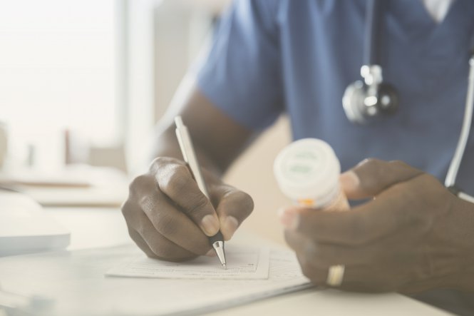 A doctor writing a prescription, relying on QoS in networking.