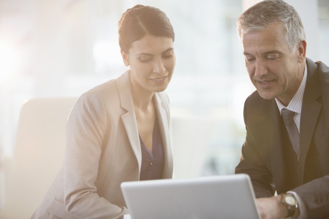 Two lawyers discuss UCaaS solutions at a law firm