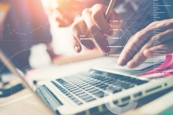Keyboard with background of financial charts representing how to increase productivity of employees