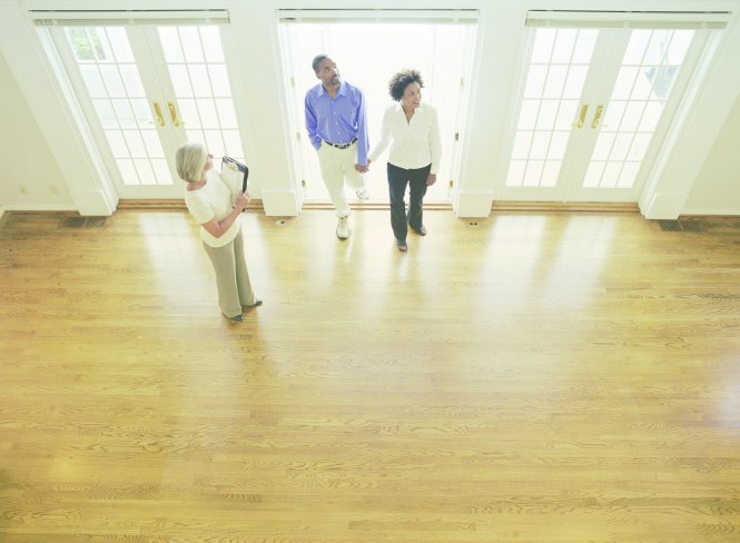 A real estate agent shows a home to clients found with good social media marketing for real estate