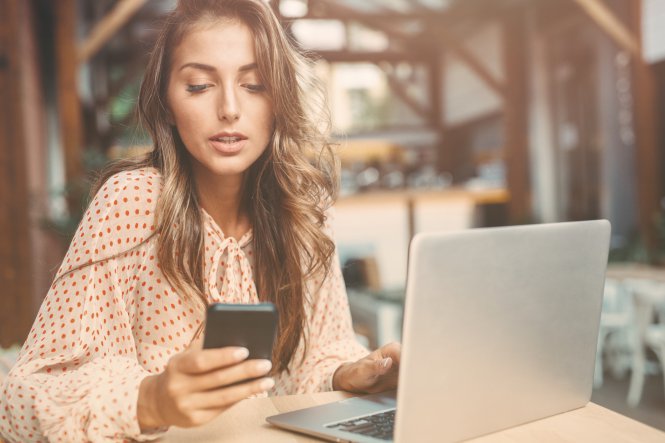 Student uses video conferencing on laptop and smartphone to communicate with online tutor