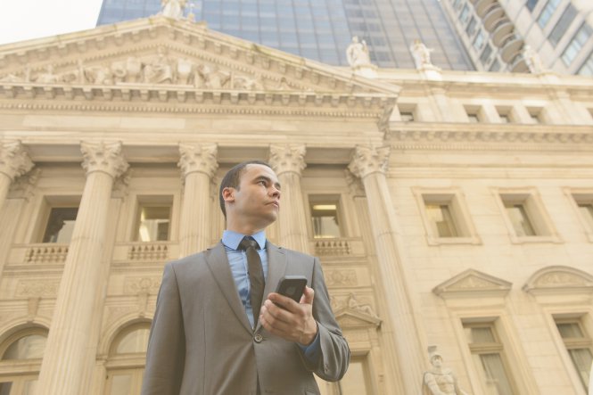 Lawyer outside courthouse on phone for law firm management