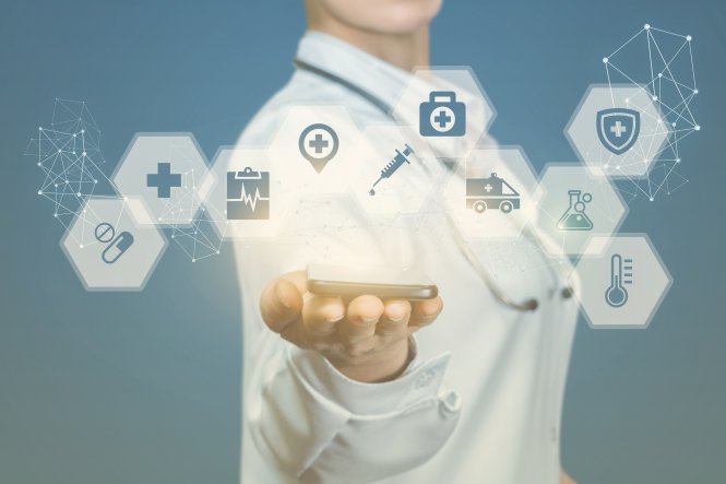 Hand holding a smartphone with symbols showing the business benefits of unified communications