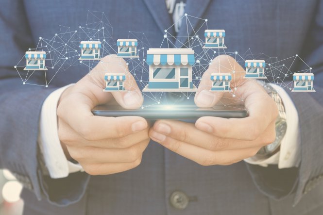 Person using mobile device with symbols representing franchise high-volume recruiting