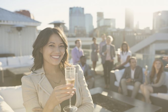 Person raising a glass of champagne while networking at the Channel Partners Conference