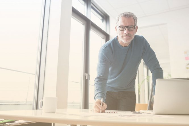 Person at desk with pen in hand building a business case for enterprise UCaaS
