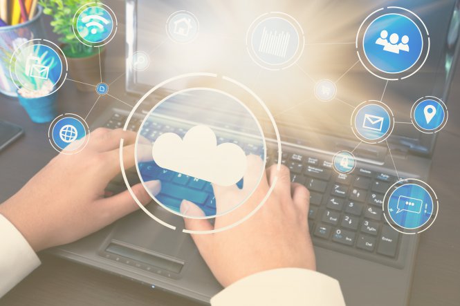 Person typing on a laptop with symbols representing cloud migration