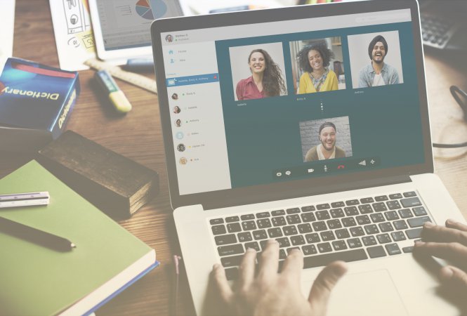 Person video conferencing with four friends via cloud communications on a laptop