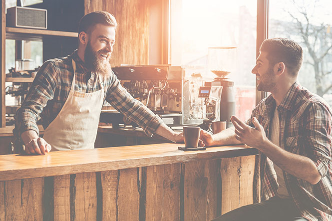 Barista smiling and talking with coffee shop customer — top customer service quotes
