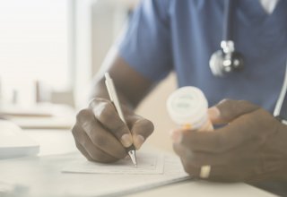 Doctor writing a prescription and exemplifying QoS in networking