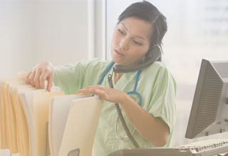 Two women viewing a laptop computer in an office, protected by HIPAA cloud compliance.