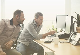 One IT worker explains the benefits of UCaaS vs. CPaaS to another