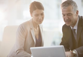 Two lawyers discuss UCaaS solutions at a law firm