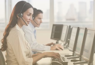 Call center employees enjoying the benefits of SIP trunking as they answer calls