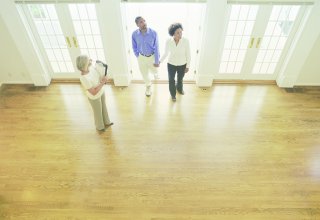 A real estate agent shows a home to clients found with good social media marketing for real estate