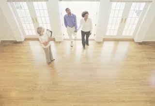 Realtor showing clients a home through cross-reality advertising