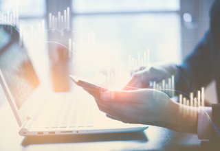 Person using a Slack integration on their smartphone and laptop