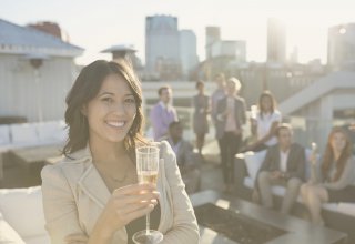 Person raising a glass of champagne while networking at the Channel Partners Conference