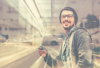 Person using mobile device to engage with a business in the city — humans and automation