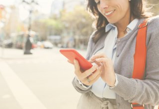 Person in a suit using a smartphone in the street — CRM utilization